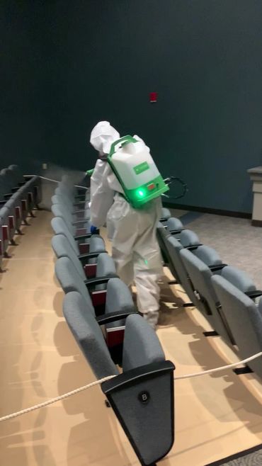Technician disinfecting auditorium after a Coronavirus Covid-19 pandemic.  Disinfection services