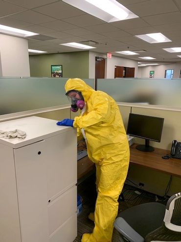 Technician cleaning and disinfecting for coronavirus Covid19 pandemic in office building