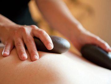 Hot stone massage in process