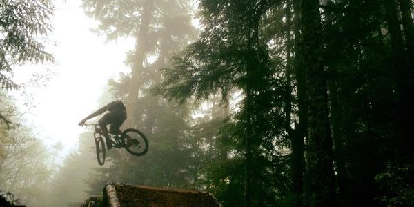 A picture of the man jumping high with bicycle