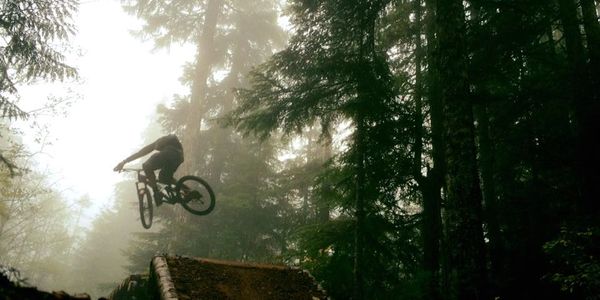 A picture of the man jumping high with bicycle
