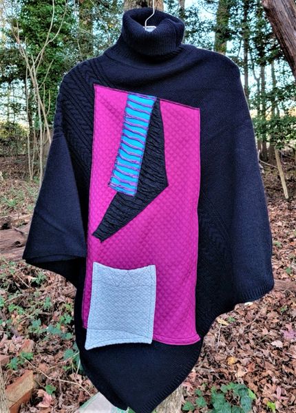 Black knit poncho swatched with rasberry, turquoise & grey