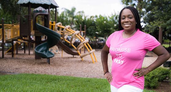 alt="Christian woman and CEO modeling for Promise Principles at a park"