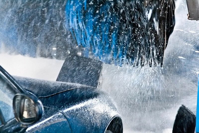 Carwash cleaning blue car