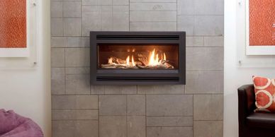 Pacific energy esprit gas log fire with louvre fascia ,on tiled wall.