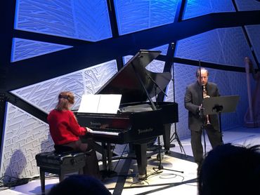 Diverse musicians performing live on a concert stage.

