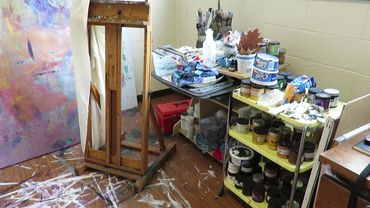 Chillon Leach's studio showing easel, brushes, and paints used for church textiles and urn palls.