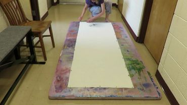 Chillon Leach pinning fabric in preparation for painting church textiles and cremation urn palls