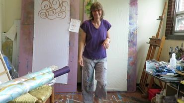 Chillon Leach smiles in her studio with prepared fabric, church textiles, and cremation urn palls.