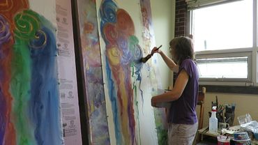 Chillon Leach painting altar parament church textiles in her studio.