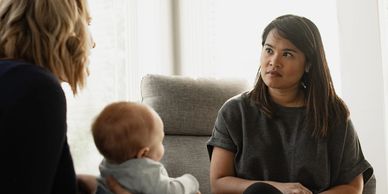 Marnellie talking with a postpartum parent