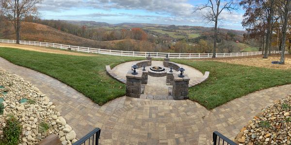 Paver walkway with fire pit, seating walls, and columns