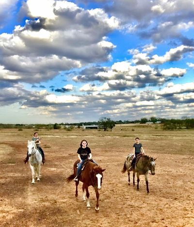 riders in pasture