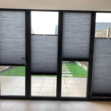 Duette tension fitted blinds. Floating on bi fold windows.