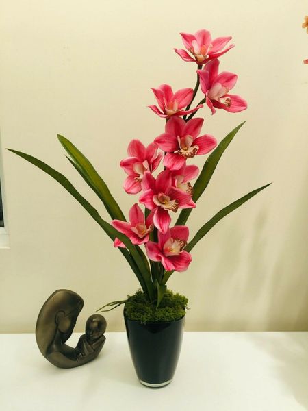 PINK REAL TOUCH CYMBIDIUM ORCHID PLANTED ARRANGEMENT WITH LEAVES IN BLACK GLASS PLANTER