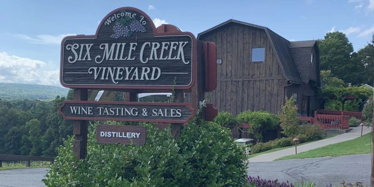 picture of our sign with tasting room barn in background