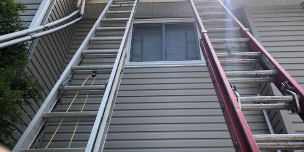 Ladders set up on house