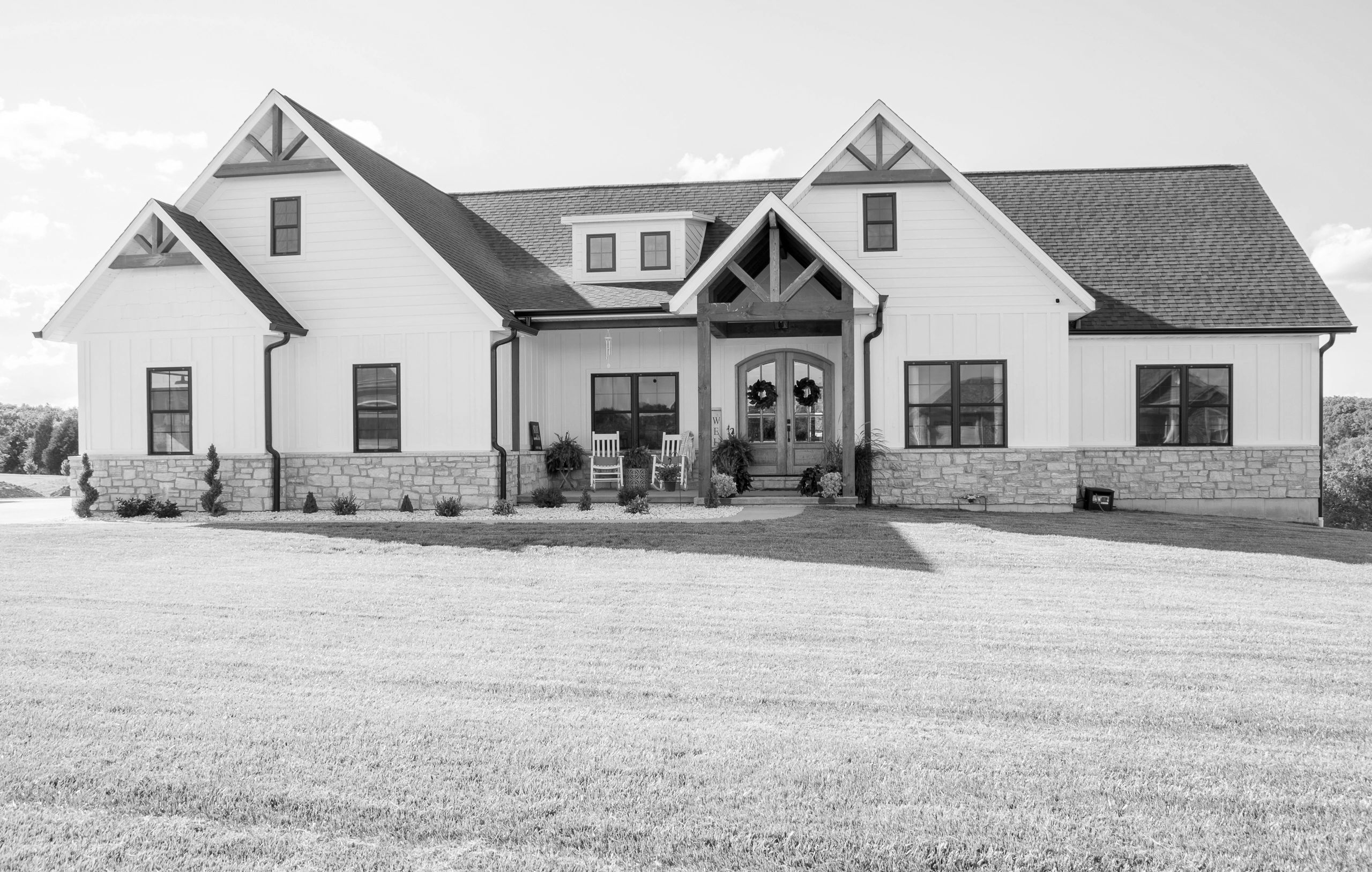 beautiful farm house with stone accents and wood beams. 