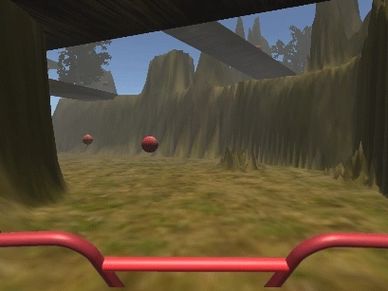 First-person view of riding a bike through a forest trail in a video game.