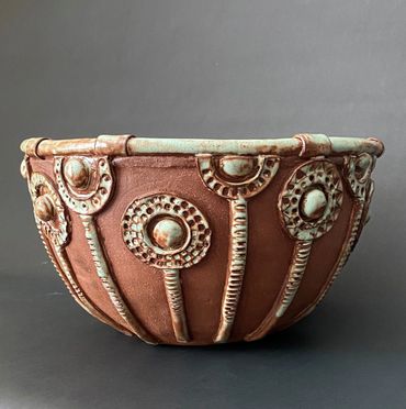 Marigolds Bowl. Hand-formed stoneware bowl with relief design. 
13” x 8” $250. 