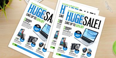 Flyers advertising a huge sale with up to 50% off on electronics.