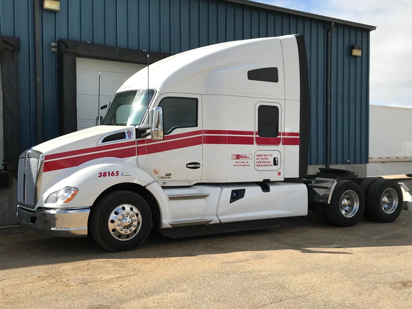 Sioux Falls Trucking Jobs Provider XFreight Shares A White Truck Cab With Red Stripes Outside