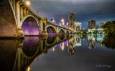 Minneapolis at night from near the Third Avenue Bridge in Minneapolis. Purple tones honoring Prince