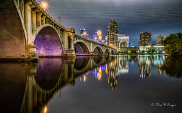 Minneapolis at night from near the Third Avenue Bridge in Minneapolis. Purple tones honoring Prince