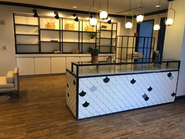 black metal shelves with wooden fish scale front desk for spa at La Cantera Resort.