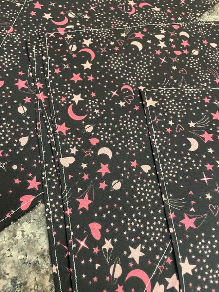 Pink stars and moons on black