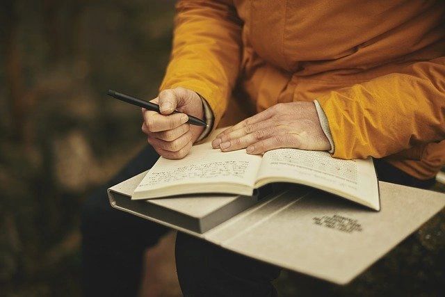 a person writing in a notebook