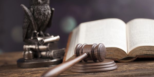 A judge's gavel and legal books symbolizing justice and law.