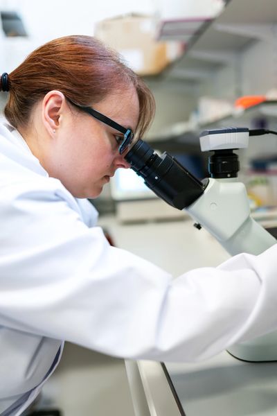 Lab worker using microscope