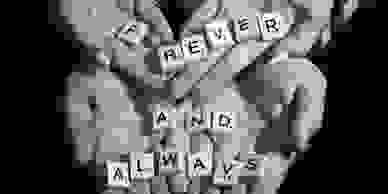 Engagement photo of couples hands with engagement ring and scrabble pieces spelling "Forever and Alw