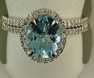 76 Round Brilliant Diamonds Oval Light Blue Stone Halo