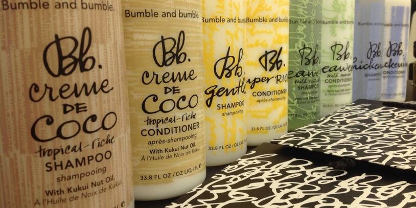 Assorted Bumble and Bumble hair care bottles lined up in a row.