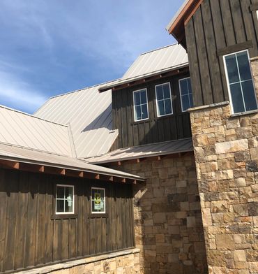 <img src="house exterior.jpg" alt="house exterior with stone and board and batten siding">