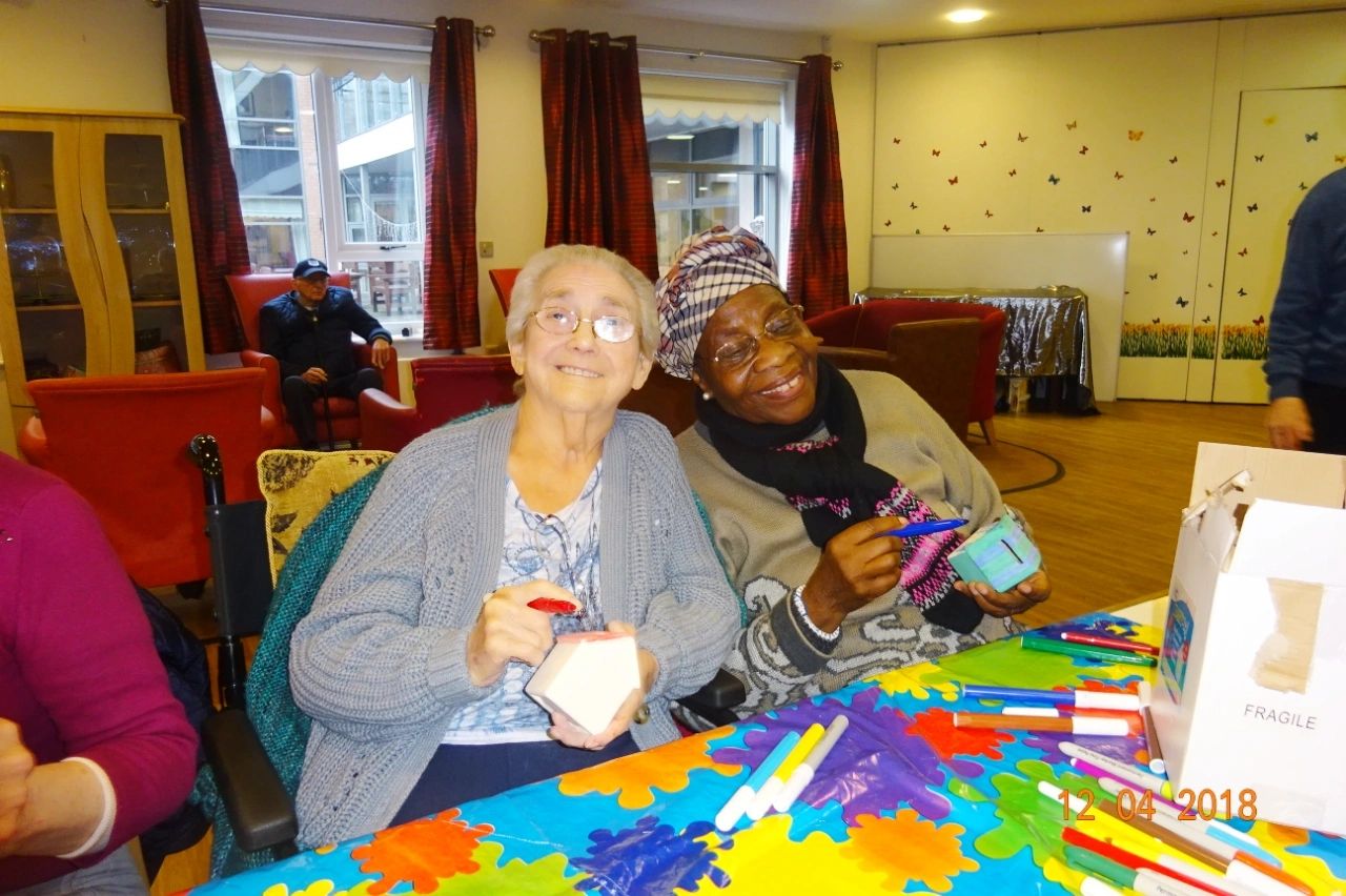 2 elderly women with Dementia doing Arts & Crafts with support from a Bereavement Charity.