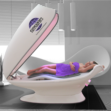 Woman having a rejuvenating moment in our Cocoon Wellness pod Pro at Imagine wellness spa Cape Coral
