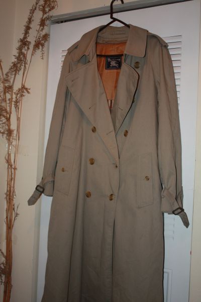 BURBERRYS RAINCOAT. 50 inches long and 21 inches across shoulders. FOR MAN OR WOMAN