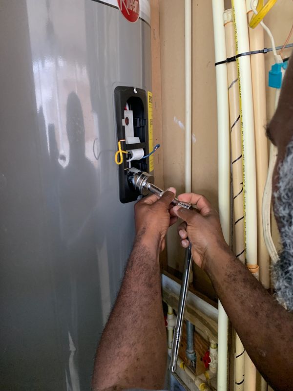 Our Master/ Lead Plumber servicing a 40 gallon Electric Water (change out elements). 