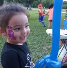 Poppy face painting & balloon sword at neighborhood park from our Face Painter in Houston