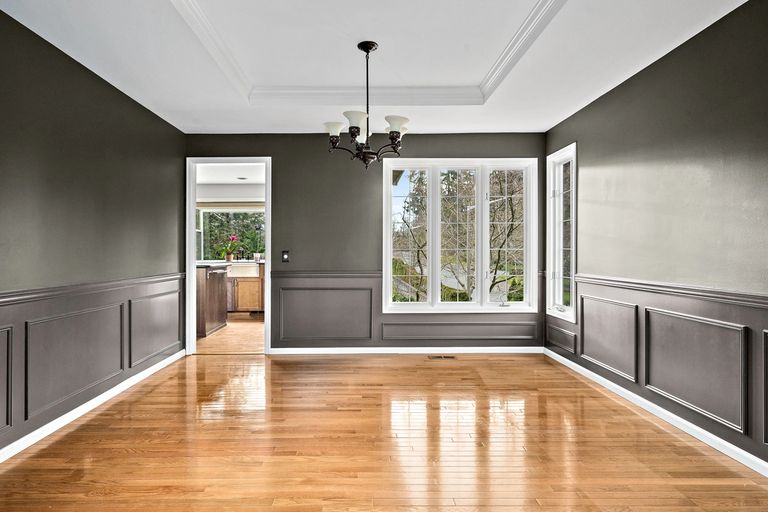 Interior Living room. Night gray semi gloss painted walls on a glossy refinished wood floor.