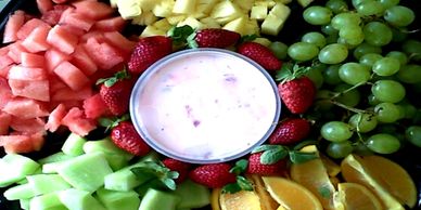 A delicious array of fresh colourful fruit, comprising of oranges,strawberries, pineapples, watermel