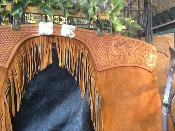 Floral basket combination tooled top custom chaps. Top grain suede side out. Square sterling plated conchos