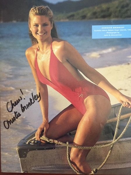 BRINKLEY, CHRISTIE SIGNED PHOTO 8 X 10 1980 SEXY MODEL ON BOW OF ROWBOAT