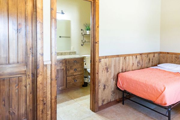 This is an image of a bed and en suite bathroom.