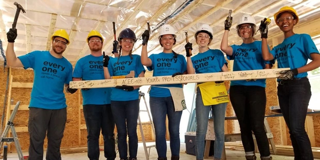 Group of volunteers building a home