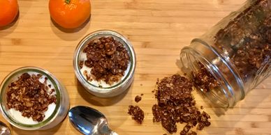 Granola on top of yogurt served with mandarines on the side.