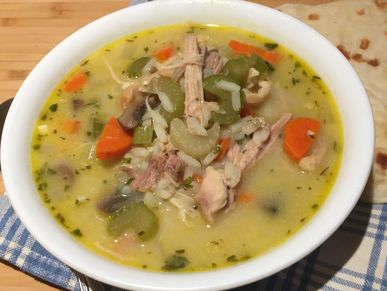 Creamy chicken and rice soup served with naan bread.